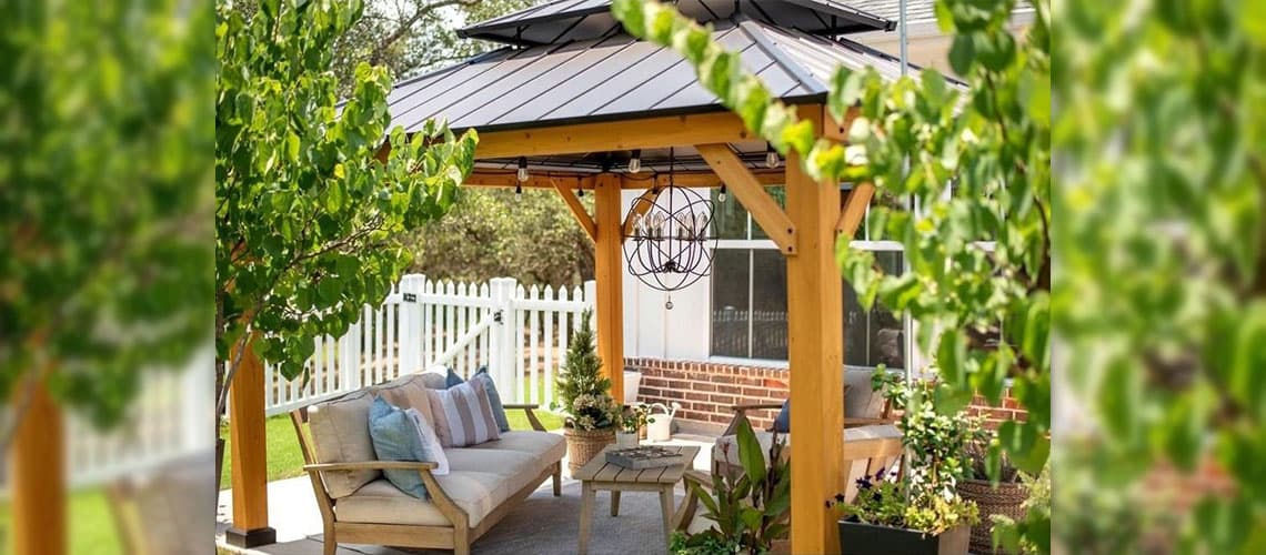 String Lights and an Orb Outdoor Chandelier Hanging from an Outdoor Gazebo in a Backyard